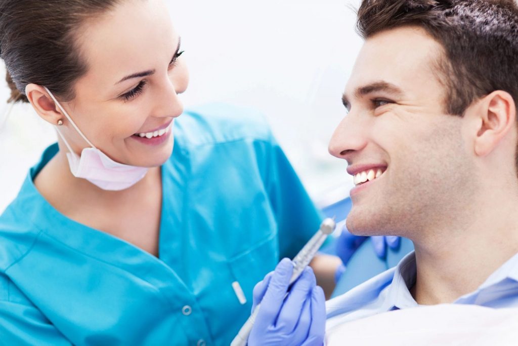 A dentist examining a patient.